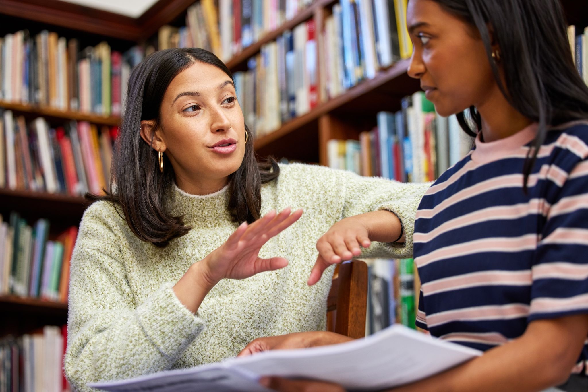 A student meeting individually with a teacher.