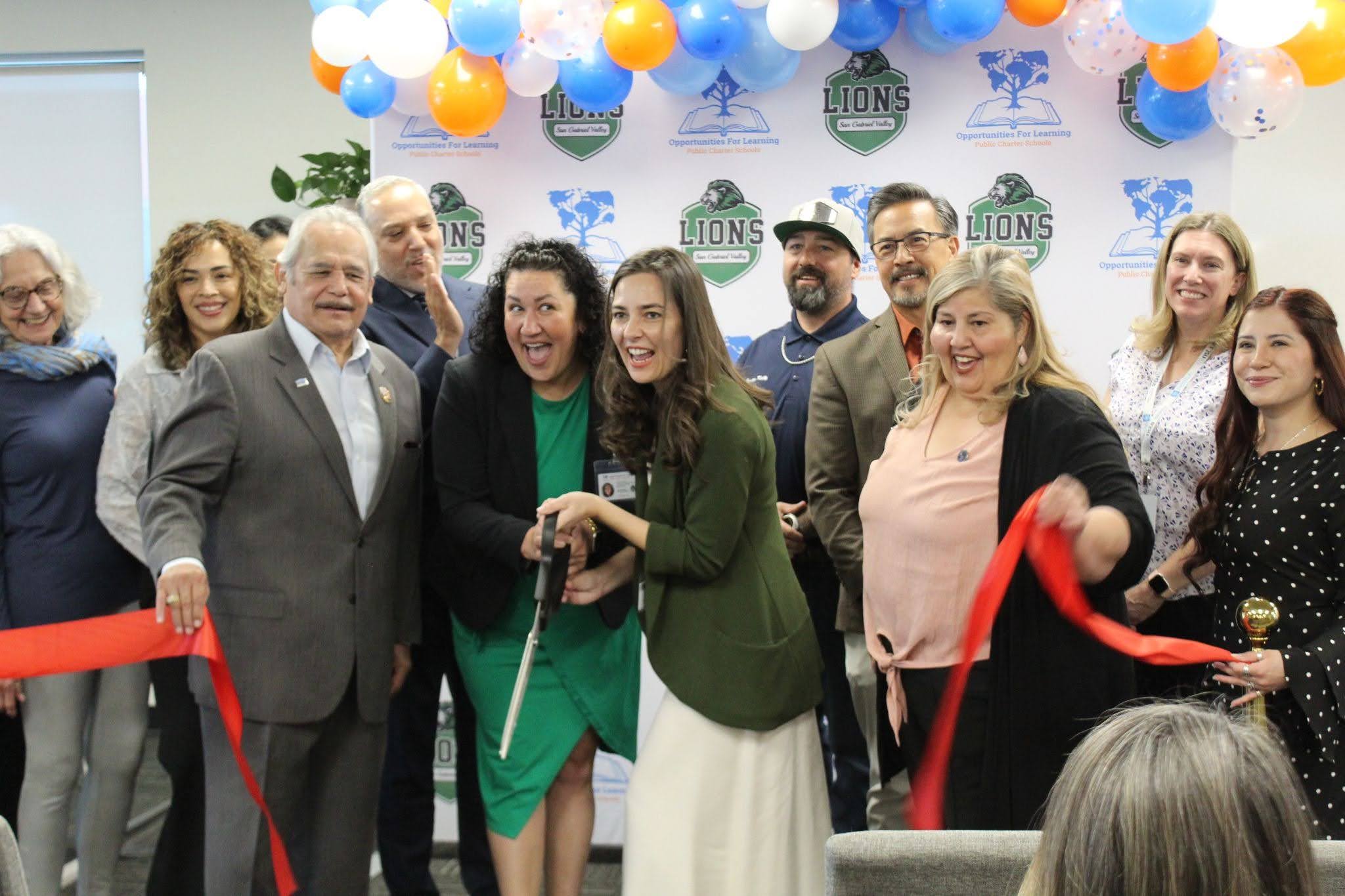 Ribbon-cutting ceremony during OFL-Baldwin Park’s 25th anniversary celebration with staff, students, and community leaders.