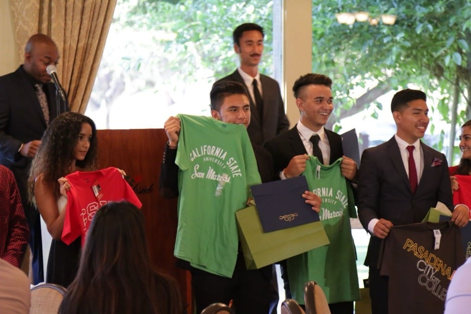CREW students holding shirts.