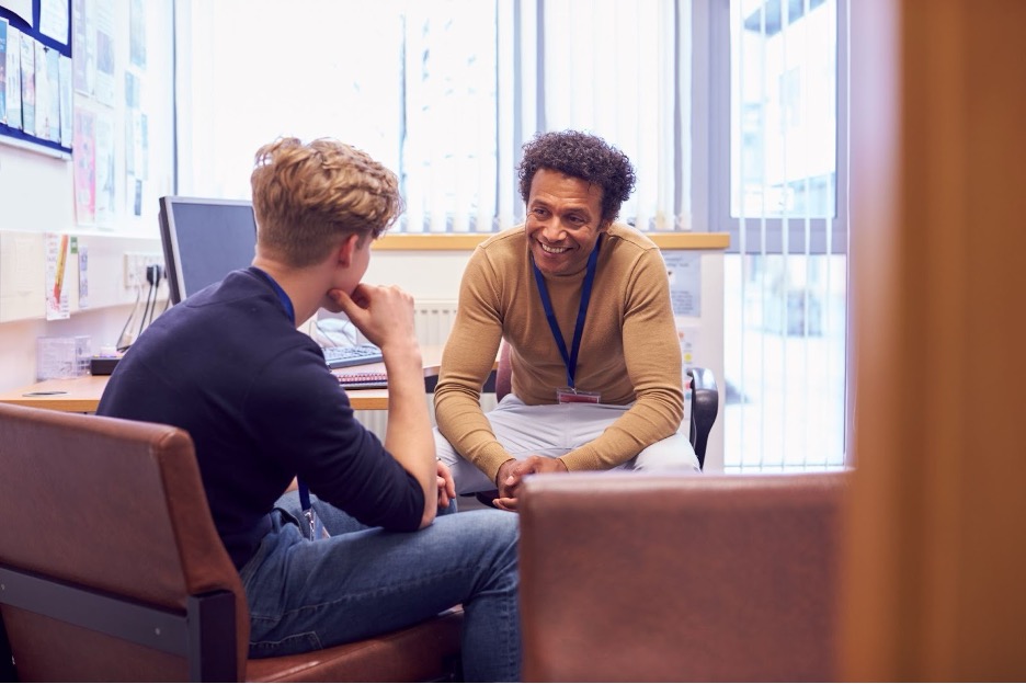 A counselor helping a foster student with enrollment paperwork.